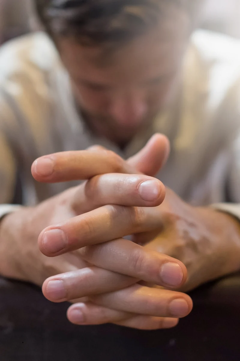 A person praying while facing a difficult season